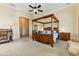 Large main bedroom with vaulted ceilings, a four-poster bed, and sitting area at 20609 N Canyon Whisper Dr, Surprise, AZ 85387
