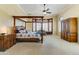 Spacious main bedroom with a canopy bed, sitting area, and custom wardrobe at 20609 N Canyon Whisper Dr, Surprise, AZ 85387