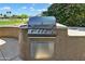High-end outdoor grill area with a built-in grill and views of the lush landscaping and golf course at 20609 N Canyon Whisper Dr, Surprise, AZ 85387