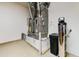 Utility room containing two furnaces, a water softener, and sealant bucket on epoxy floor at 20609 N Canyon Whisper Dr, Surprise, AZ 85387