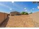 Vacant backyard with a view of the home's exterior, a block wall, and a detached shed at 2136 W Pickett Ct, San Tan Valley, AZ 85144