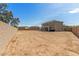 A vacant backyard with a block wall and an exterior view of the house at 2136 W Pickett Ct, San Tan Valley, AZ 85144