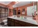 A bathroom with a double sink vanity, a framed mirror, and a decorative giraffe art piece at 2136 W Pickett Ct, San Tan Valley, AZ 85144