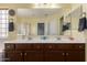 Bright bathroom featuring a double sink vanity and large mirror at 2136 W Pickett Ct, San Tan Valley, AZ 85144