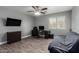 This room features wood tile floors, a ceiling fan, and a mounted TV at 2136 W Pickett Ct, San Tan Valley, AZ 85144