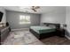 This bedroom has tile floors, a ceiling fan, and a modern-looking bed frame at 2136 W Pickett Ct, San Tan Valley, AZ 85144