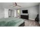 This bedroom has tile floors, a ceiling fan, and a TV at 2136 W Pickett Ct, San Tan Valley, AZ 85144