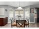 Bright breakfast nook with a marble-top table, bay windows, and stylish light fixture at 2136 W Pickett Ct, San Tan Valley, AZ 85144