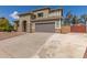 Exterior of home with a two-car garage, desert landscaping, and a concrete driveway against a blue sky at 2136 W Pickett Ct, San Tan Valley, AZ 85144
