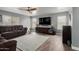 Cozy living room with hardwood floors, a ceiling fan, ample natural light, and a comfortable sofa at 2136 W Pickett Ct, San Tan Valley, AZ 85144