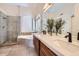 Elegant bathroom featuring double sinks, a soaking tub, and a separate glass shower at 2448 S Salida Del Sol --, Chandler, AZ 85286