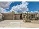 Charming home with a three-car garage, desert landscaping, and a tile roof under a partly cloudy blue sky at 2448 S Salida Del Sol --, Chandler, AZ 85286