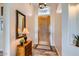 Bright and inviting foyer featuring a decorative mirror, elegant wood flooring, and a stylish wooden door at 2448 S Salida Del Sol --, Chandler, AZ 85286