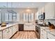 Spacious kitchen with marble countertops, stainless steel appliances, white cabinets, and ample storage at 2448 S Salida Del Sol --, Chandler, AZ 85286
