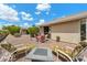 Cozy backyard patio with lounge chairs, a fire pit, and shaded seating for relaxation and enjoyment at 2673 Leisure World --, Mesa, AZ 85206