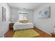 Bright bedroom, featuring wood flooring and a comfortable bed with 'happy' pillow at 2673 Leisure World --, Mesa, AZ 85206