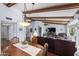 Open-concept living room and dining area with exposed wood beams and a view of the backyard at 2673 Leisure World --, Mesa, AZ 85206