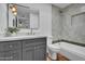 Charming bathroom with a vanity, a bathtub, and tile accents at 2814 N 62Nd N St, Scottsdale, AZ 85257