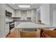 Bright kitchen featuring a large island, stylish backsplash, and modern appliances, illuminated by a skylight at 2814 N 62Nd N St, Scottsdale, AZ 85257