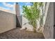 Exterior patio featuring neutral stucco walls, wrought iron gate, and desert landscaping at 2814 N 62Nd N St, Scottsdale, AZ 85257