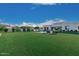 Expansive backyard features lush green lawn, pool, and contemporary home exterior at 30271 N 117Th Dr, Peoria, AZ 85383