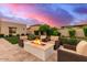 Expansive backyard with a cozy fire pit and outdoor seating at 30271 N 117Th Dr, Peoria, AZ 85383