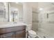 A bathroom features a vanity with a mirror and a tiled glass shower at 30271 N 117Th Dr, Peoria, AZ 85383