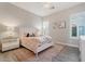 Inviting bedroom with a white woven headboard and light pink accents at 30271 N 117Th Dr, Peoria, AZ 85383