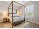 Bedroom features a four-post bed and natural light from the window at 30271 N 117Th Dr, Peoria, AZ 85383