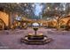 Charming courtyard featuring a fountain, seating area, and outdoor lighting at 30271 N 117Th Dr, Peoria, AZ 85383