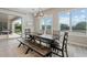 Bright dining area with natural light, a rustic table and access to outdoor space at 30271 N 117Th Dr, Peoria, AZ 85383