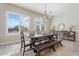 Bright dining area with natural light, a rustic table and contemporary decor at 30271 N 117Th Dr, Peoria, AZ 85383