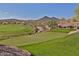 Scenic view of the lush green golf course with mountain views in the background at 30271 N 117Th Dr, Peoria, AZ 85383