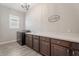 A spacious laundry room features a modern washer and dryer and a large countertop workspace at 30271 N 117Th Dr, Peoria, AZ 85383