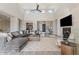 Spacious living room with fireplace, high ceilings, ceiling fan, and plenty of natural light at 30271 N 117Th Dr, Peoria, AZ 85383
