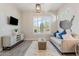 Bright living room features a sofa with accent pillows and natural light from the window at 30271 N 117Th Dr, Peoria, AZ 85383