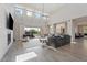 Open concept living room with high ceilings, fireplace, and sliding doors to the backyard at 30271 N 117Th Dr, Peoria, AZ 85383
