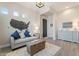 A charming living room features an accent wall map and comfortable, bright, furniture at 30271 N 117Th Dr, Peoria, AZ 85383