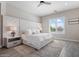 A bright main bedroom features a large, padded headboard and views from the window at 30271 N 117Th Dr, Peoria, AZ 85383