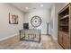 Bright home office featuring a desk, chair, decorative shelving, and an oversized clock at 30271 N 117Th Dr, Peoria, AZ 85383