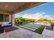 Outdoor patio with comfortable seating, string lights, and a beautiful view of the pool and backyard at 30271 N 117Th Dr, Peoria, AZ 85383