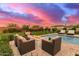 Gorgeous backyard pool area with a fire pit, water features, and comfortable seating at 30271 N 117Th Dr, Peoria, AZ 85383