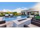 Sparkling pool with fountains, comfortable loungers and a modern outdoor fire pit at 30271 N 117Th Dr, Peoria, AZ 85383