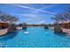 Stunning resort-style pool with fountains, cabanas, and decorative stone accents for luxurious outdoor living at 30271 N 117Th Dr, Peoria, AZ 85383
