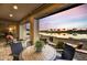 Stylish covered patio with furniture, golf course and lake views creates an inviting outdoor space at 3086 S First Water Ln, Gold Canyon, AZ 85118