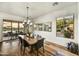 Elegant dining room with wood floors, views of the community, and modern lighting and mirrors at 3086 S First Water Ln, Gold Canyon, AZ 85118