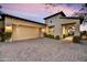 Attractive home with a two-car garage, stone driveway, and a well-manicured front yard at 3086 S First Water Ln, Gold Canyon, AZ 85118