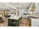 Bright kitchen features a large island, stone countertops, stainless appliances, and an open concept to the dining area at 3086 S First Water Ln, Gold Canyon, AZ 85118