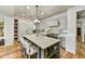 Modern kitchen with tile backsplash, large island with seating, and stainless steel appliances at 3086 S First Water Ln, Gold Canyon, AZ 85118