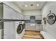 Well-organized laundry room with modern washer and dryer, ample cabinet space, and stylish tile accents at 3086 S First Water Ln, Gold Canyon, AZ 85118